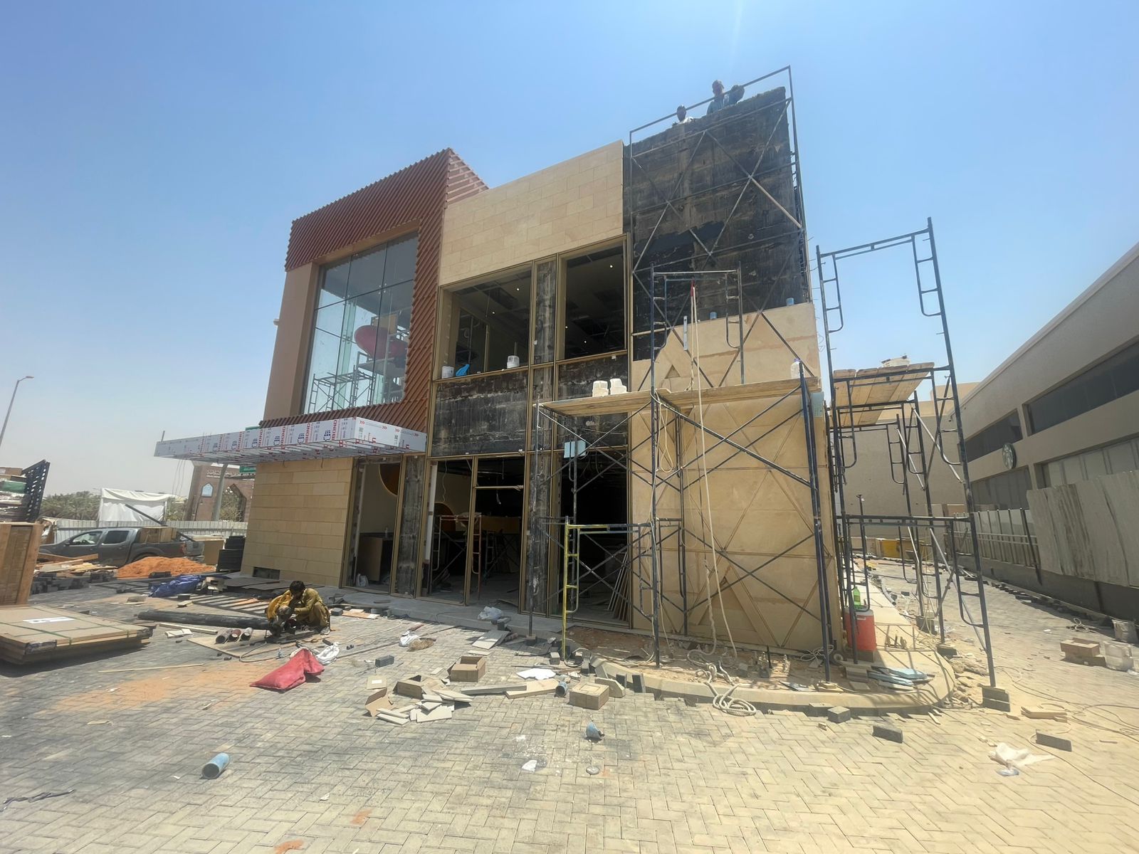 Nadah Plaza restaurant building exterior with the stone facade under construction