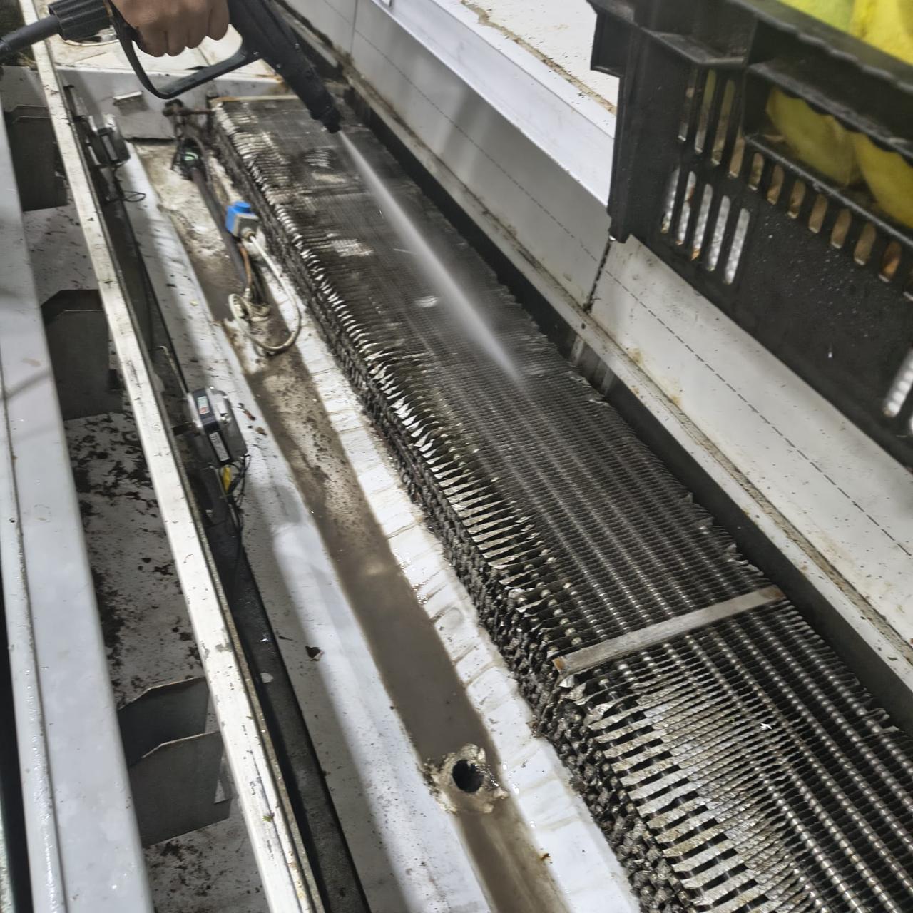 Pressure-washer lance cleaning along an exposed display case evaporator coil