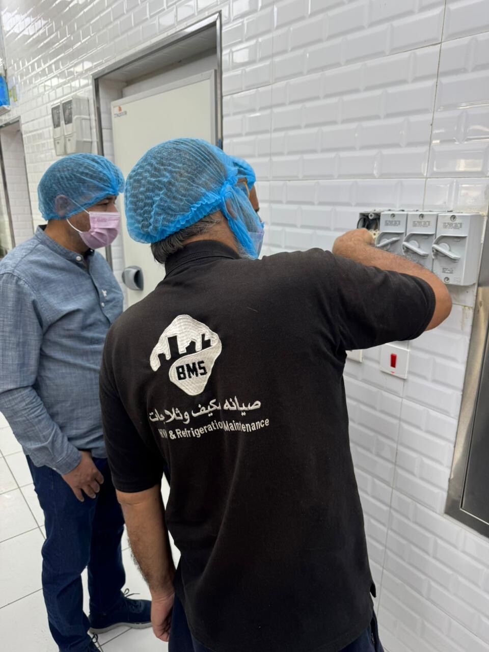 BMS technician checking isolators in a food-production area
